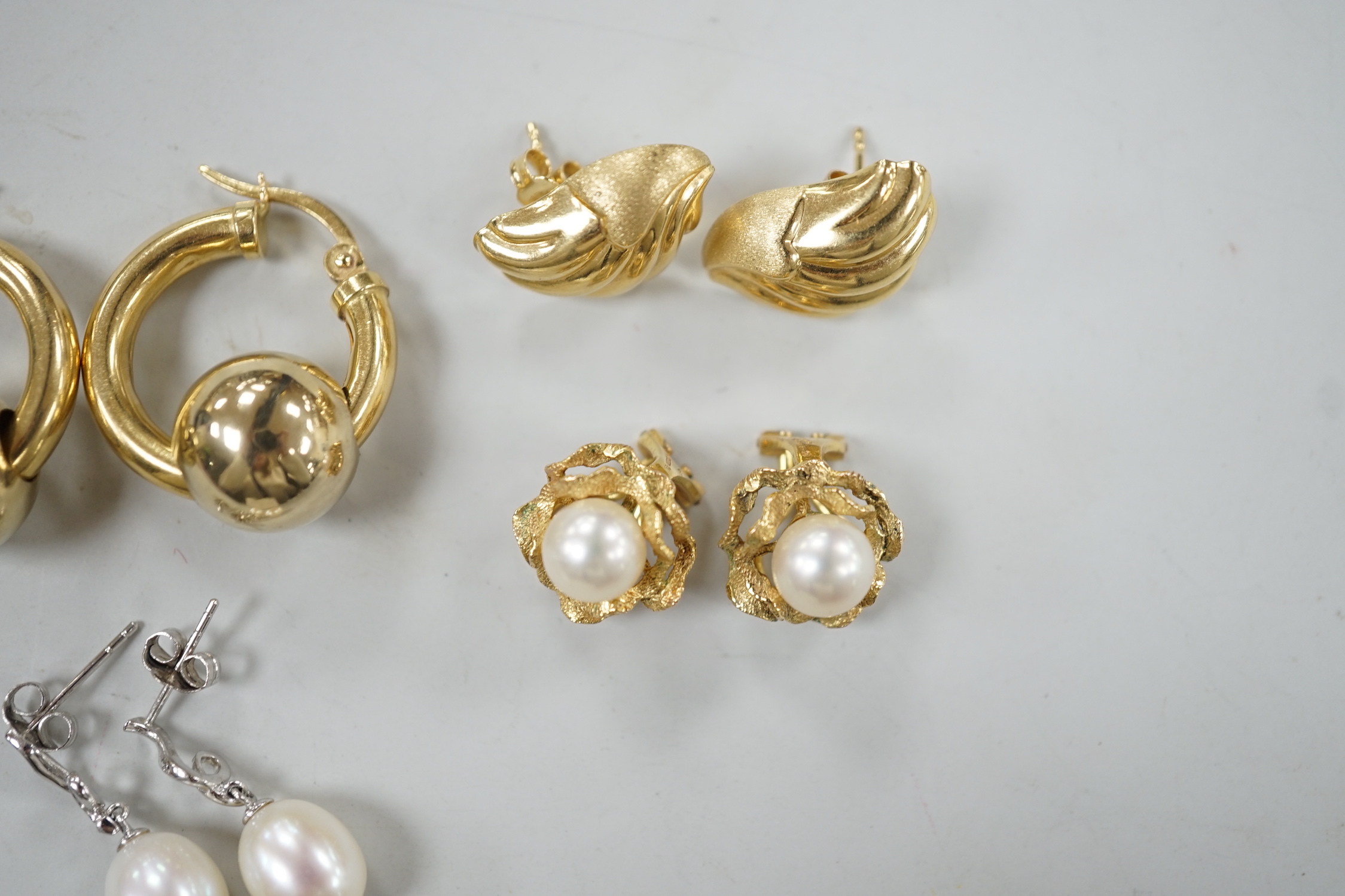 Two pairs of 750 yellow metal earrings, 12.6 grams and two pairs of 375 and cultured pearl set earrings, gross weight 7.2 grams.